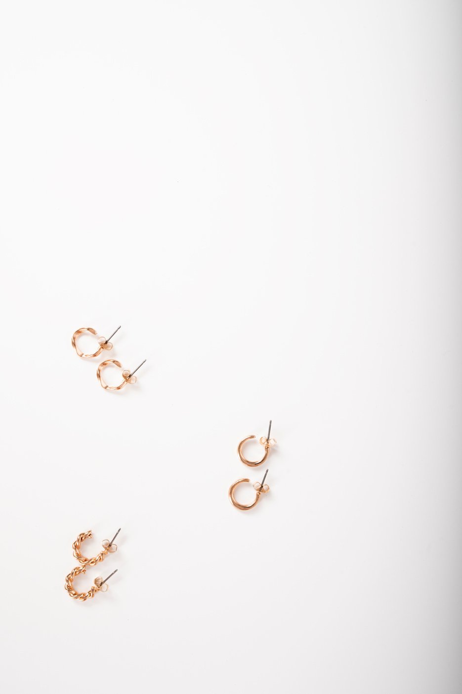 Photo of earrings top view on white background