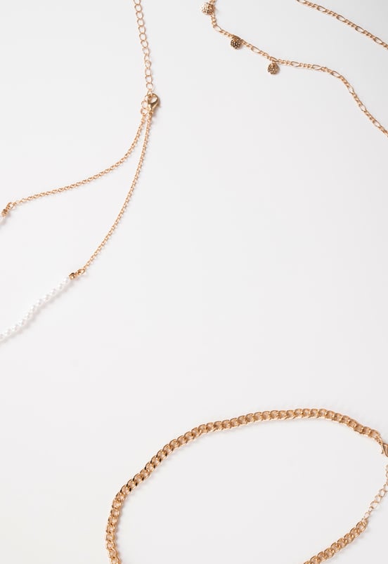 Photo of necklaces top view on white background